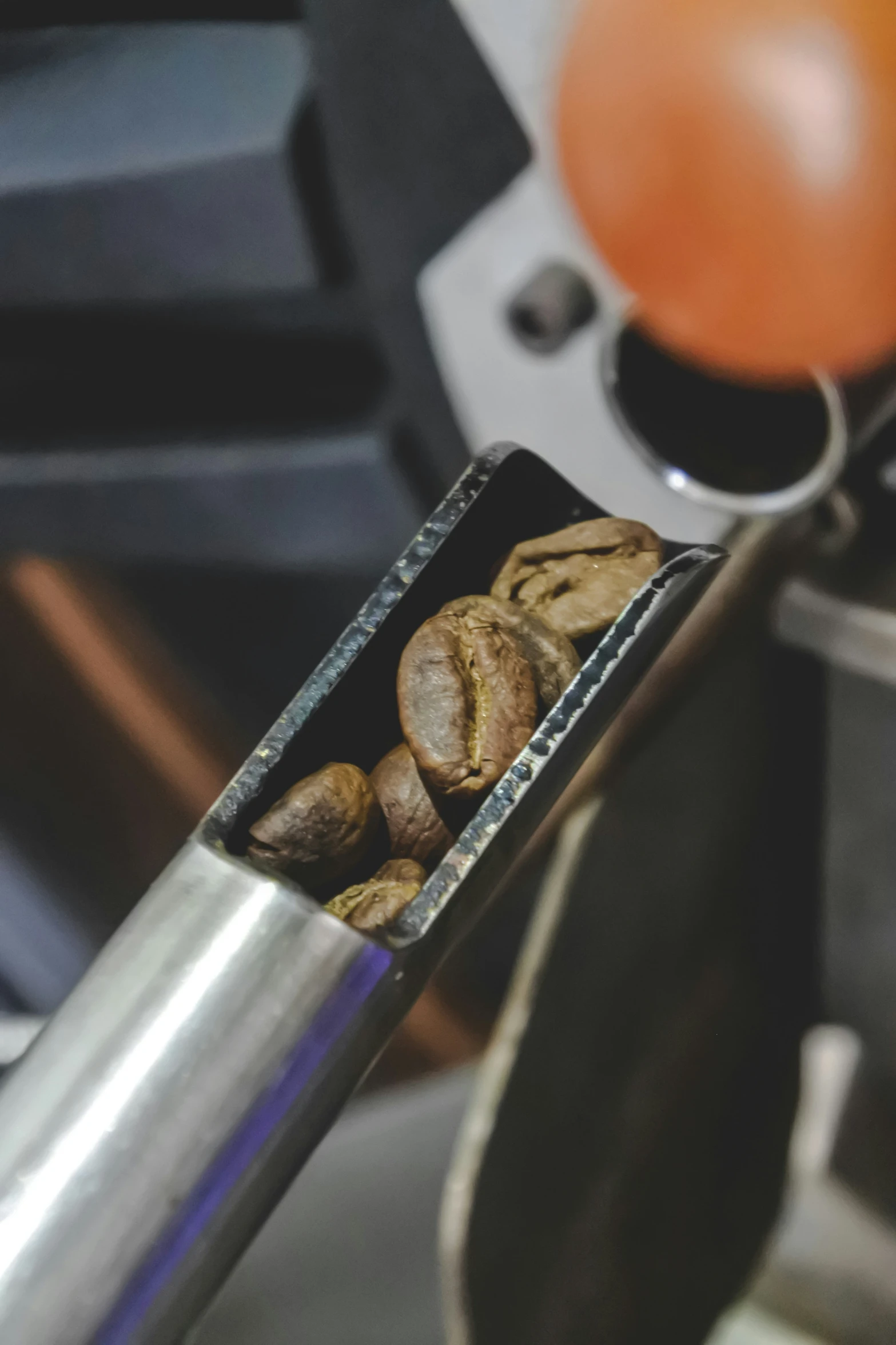 a silver coffee pot filled with cookies sitting on top of a counter