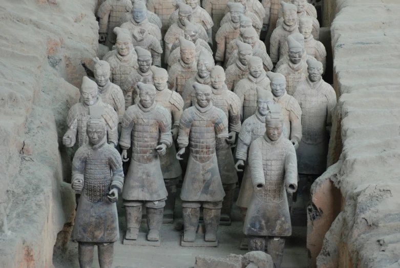 a bunch of statues are arranged and grouped together
