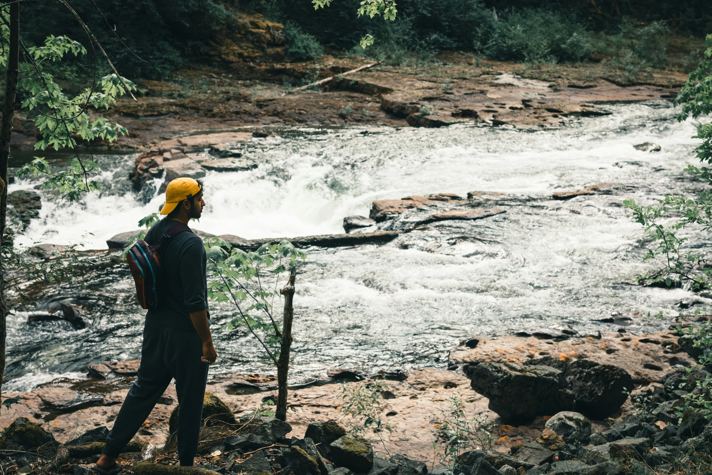 a person standing in front of a waterfall