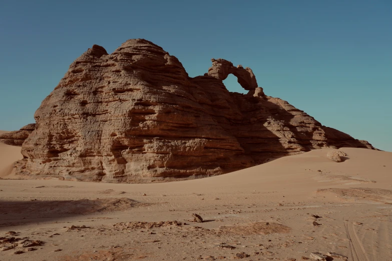 there is a small rock formation in the desert