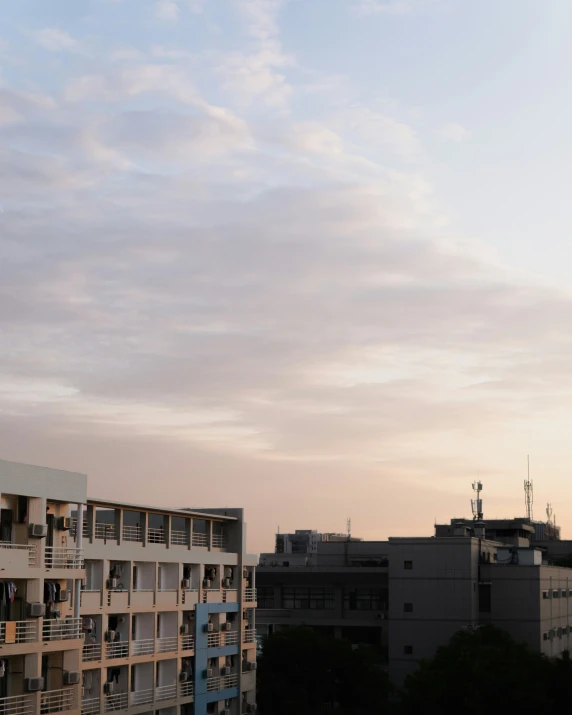 the view of an apartment building and rooftop from a distance