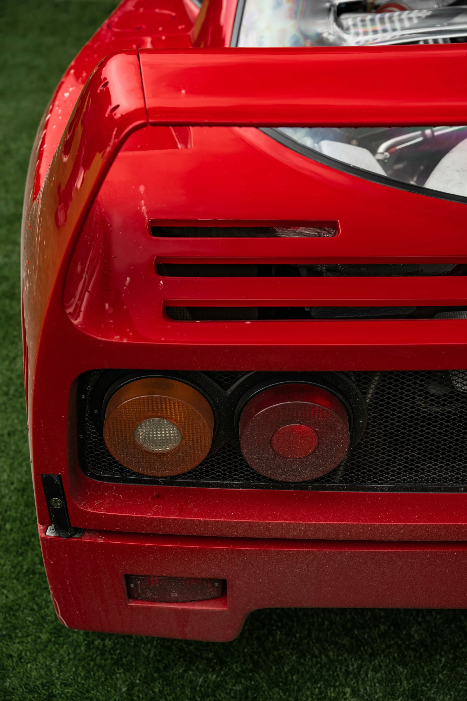 front of car in field with grass in the background