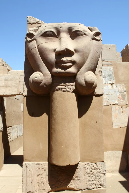 a close - up of an egyptian statue near some ancient ruins