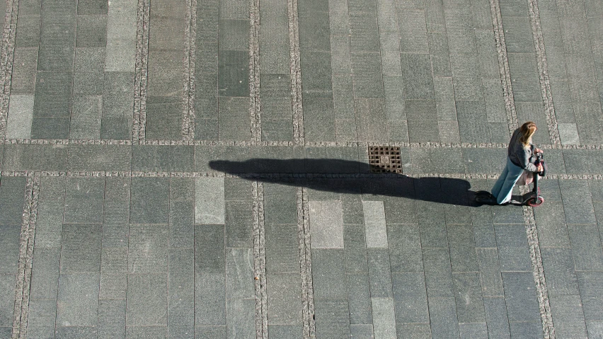 a person walks across an empty parking lot