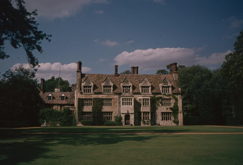 a big stone building surrounded by trees