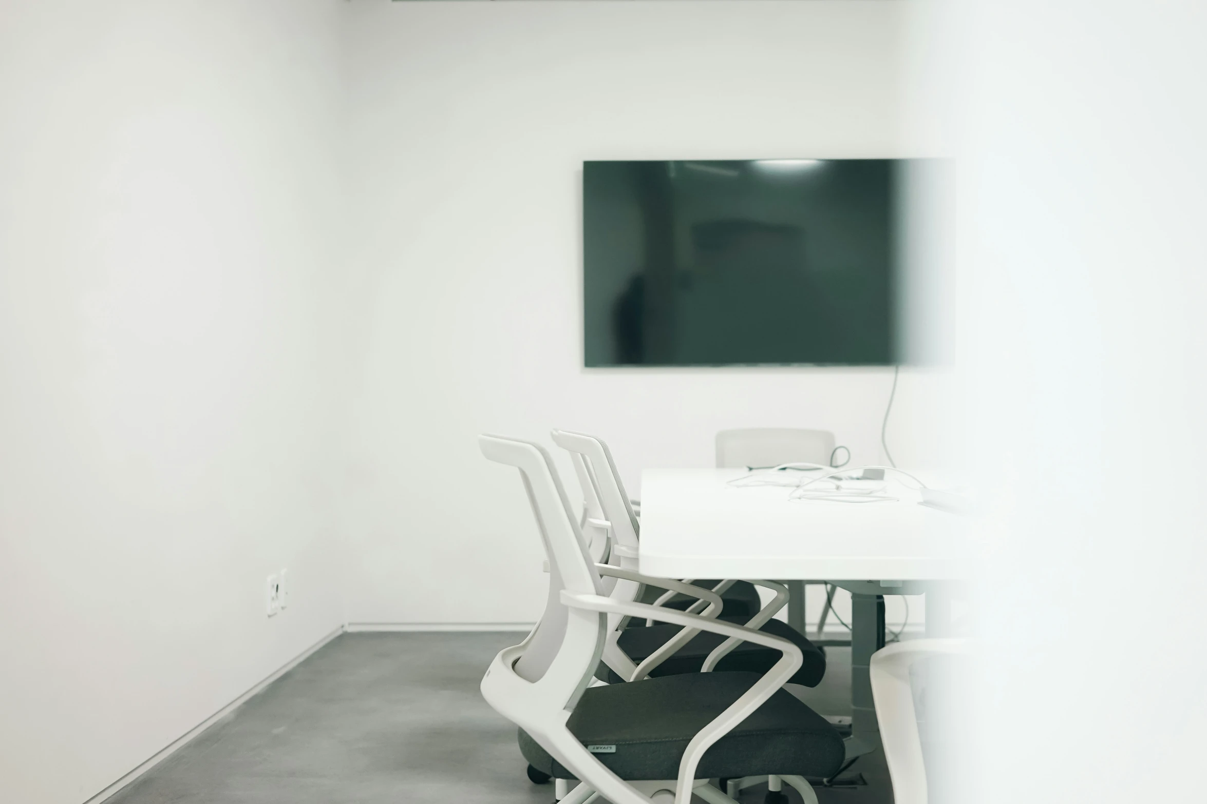 an empty room with a flat screen tv on the wall