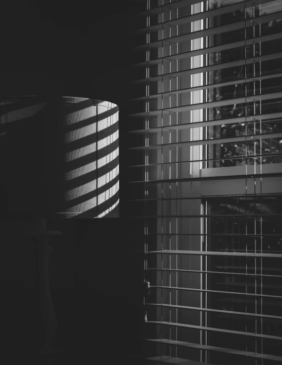 black and white po of blinds over windows with blinds on top