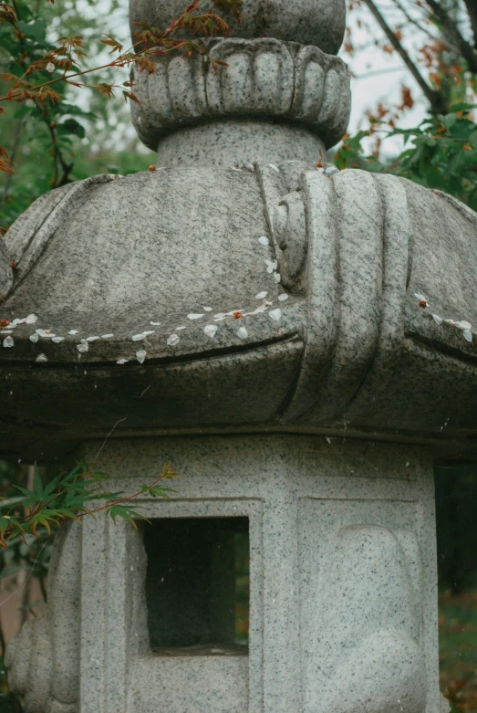 a stone sculpture that looks like an asian fish head