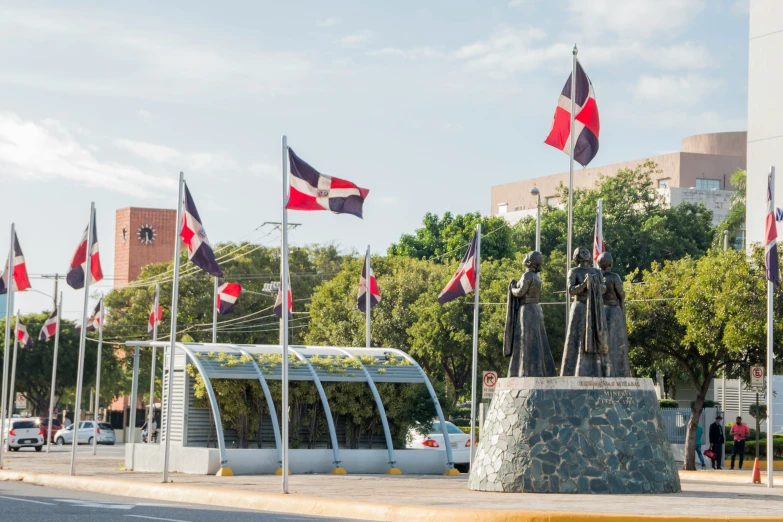 flags on poles surrounding a monument in a town