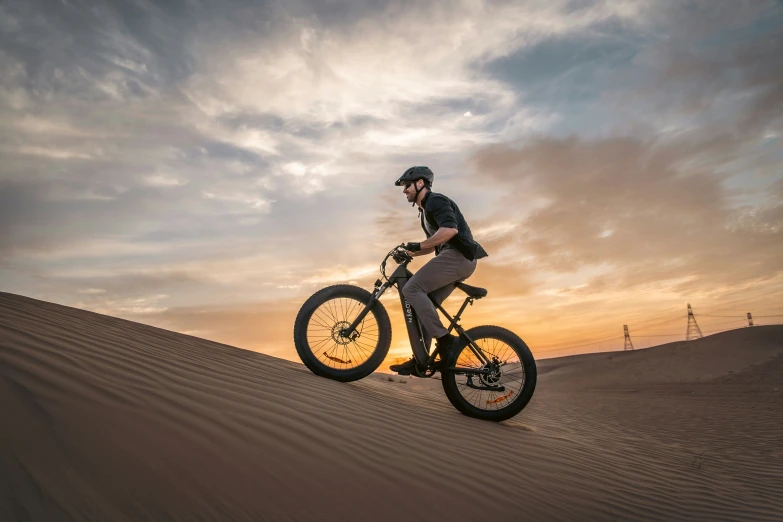 a man riding a mountain bike in the desert