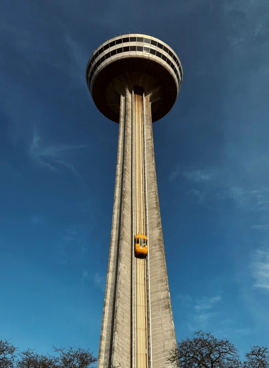 a tall stone tower with a sky in the background