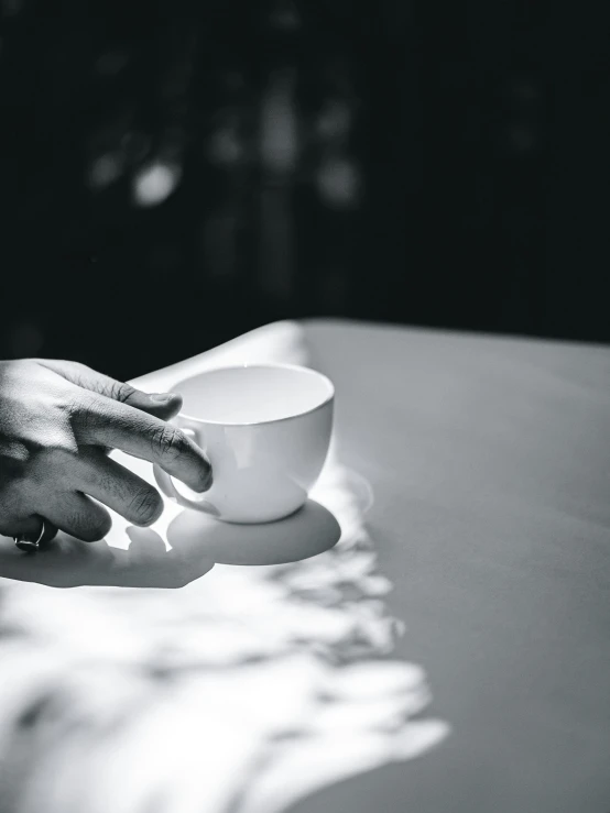 a cup in the hand of someone holding it