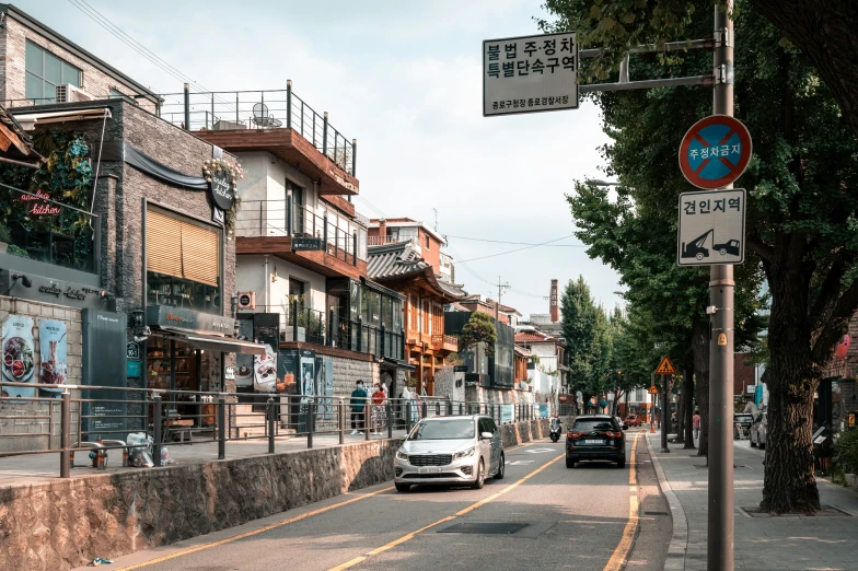 two cars driving down an empty city street