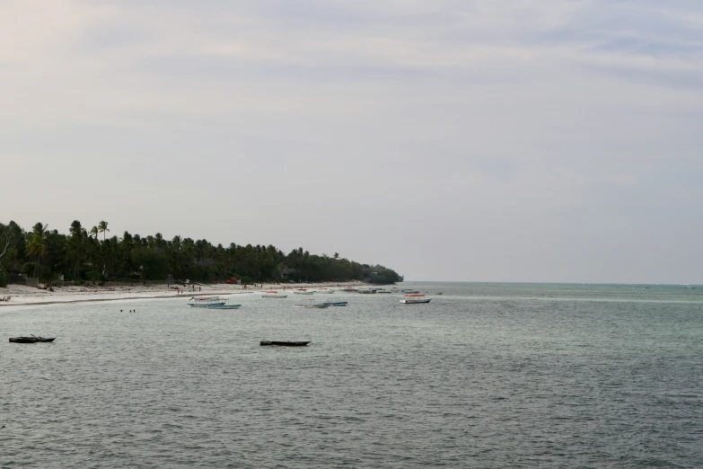 a beach with boats on it is in the water