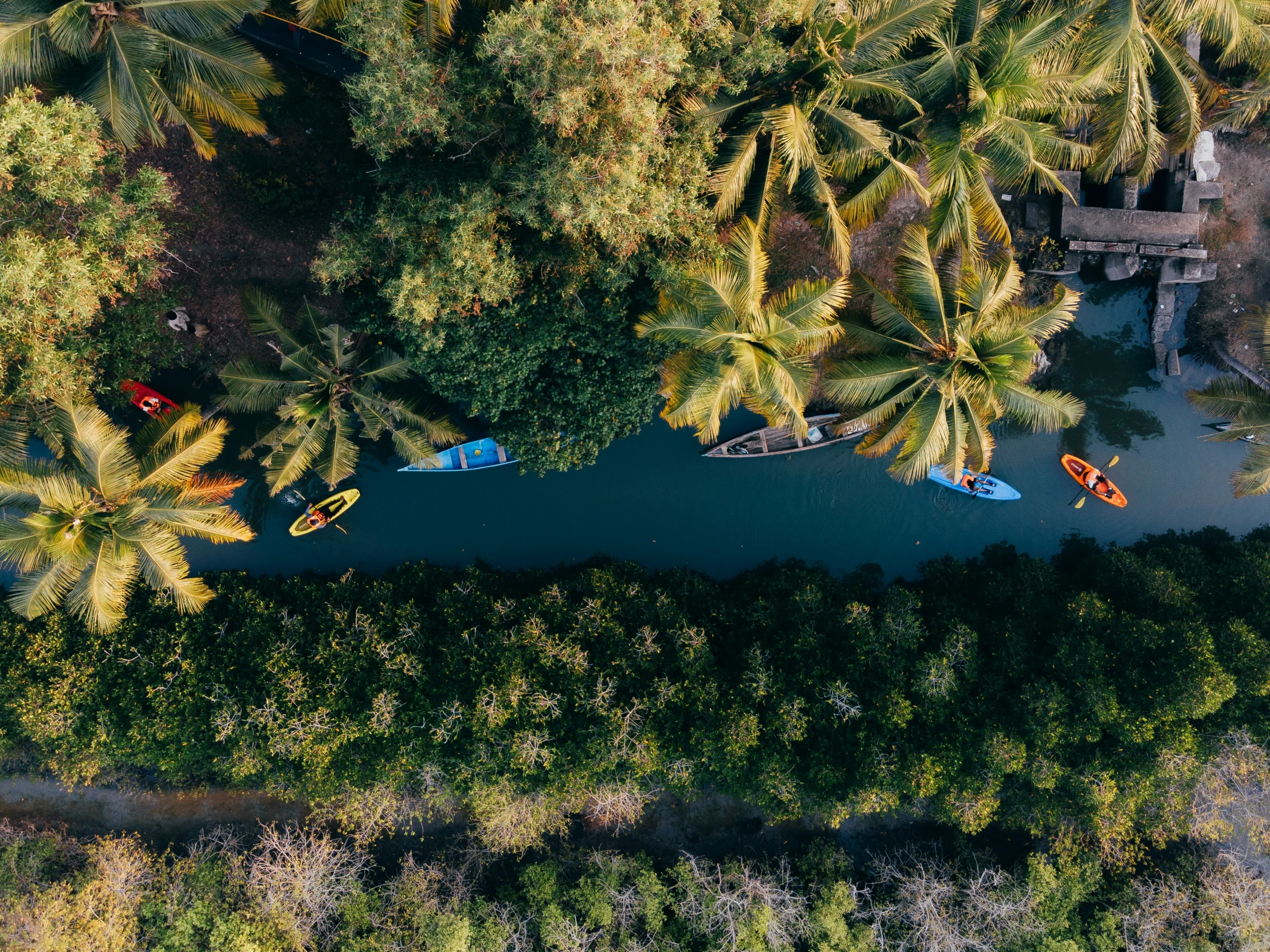 several boats are parked on the shoreline of a river