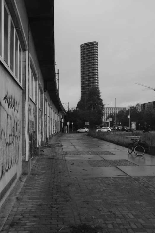 an empty city street with graffiti covered buildings