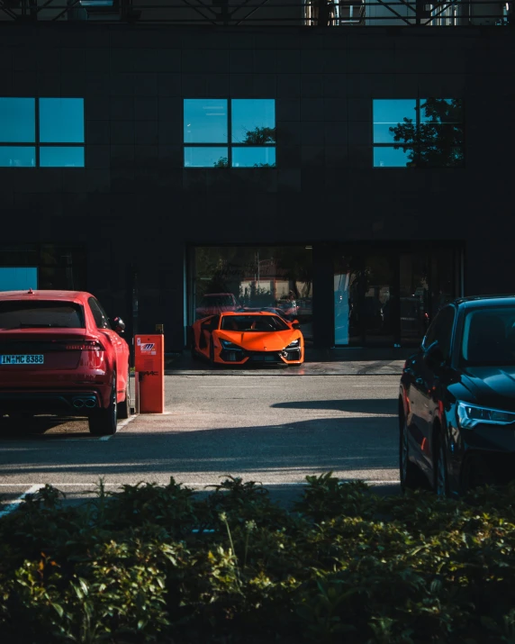 the sporty, coupe car is parked by the building