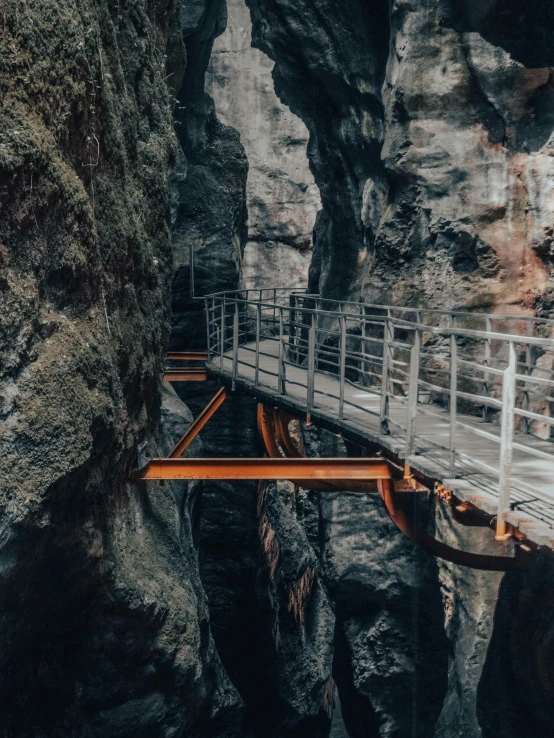 wooden bridge going through the mountain side to another cave
