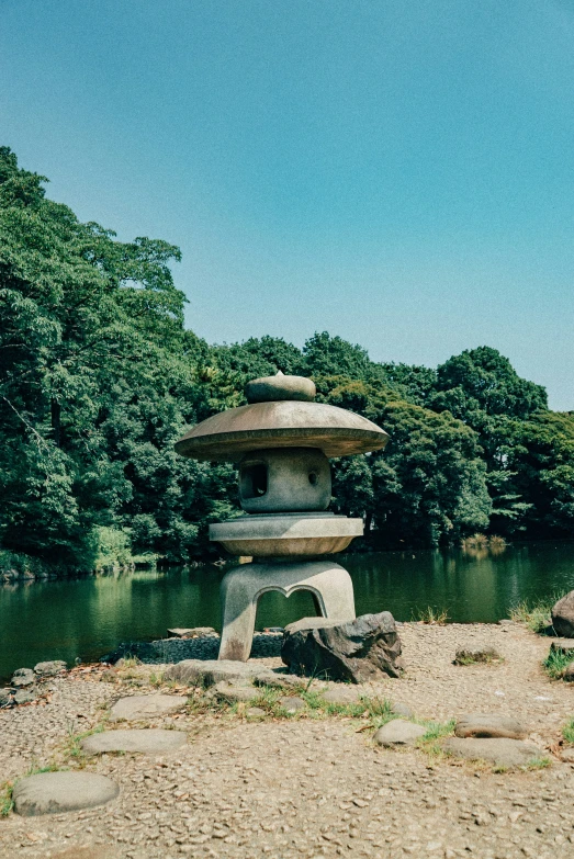 three stone temples sitting in front of a pond