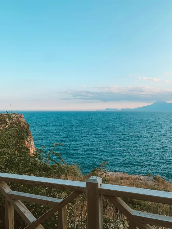 view over a sea of blue and white water from a wooden bridge