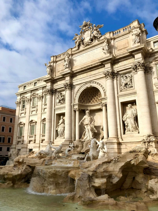 many statues on top of a tall building