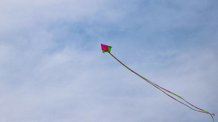 a pink kite that is flying in the air
