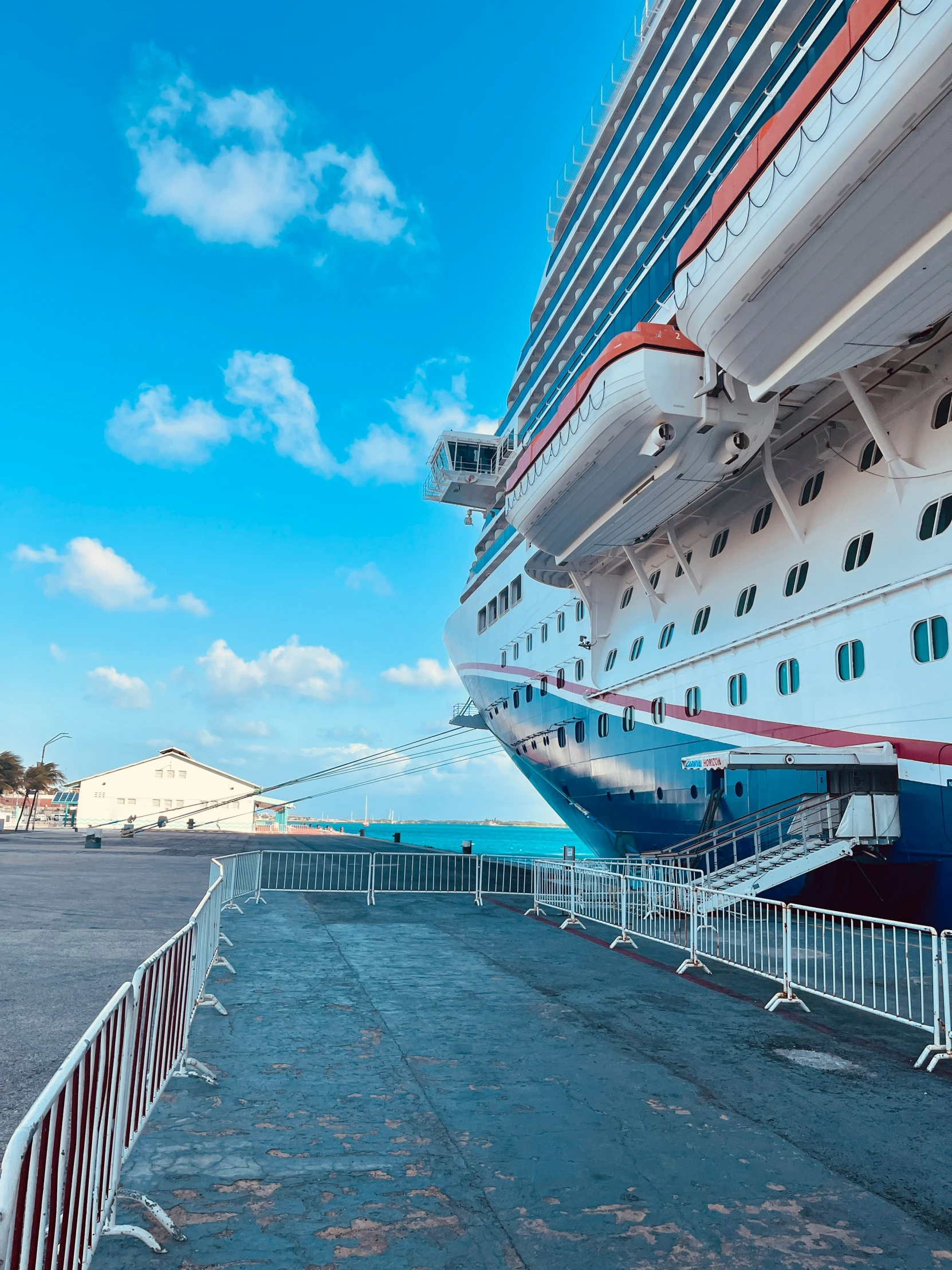 cruise ship with steps near beach with fence