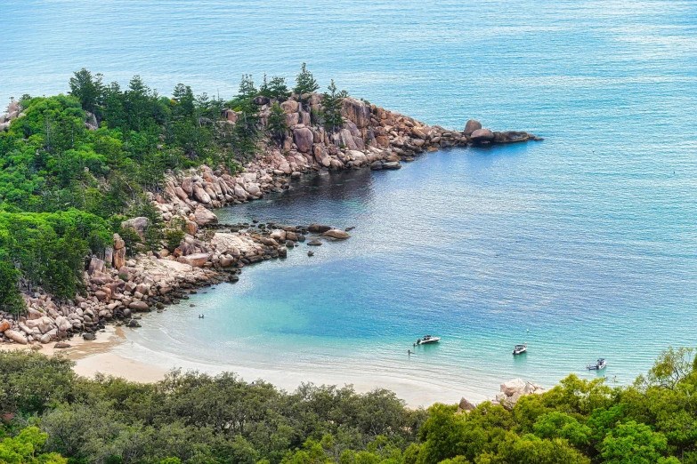 a view from above of a blue sea beach and a sandy shore and the shoreline area in the far distance