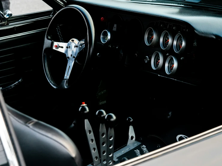 an old time car with steering wheel and dashboard