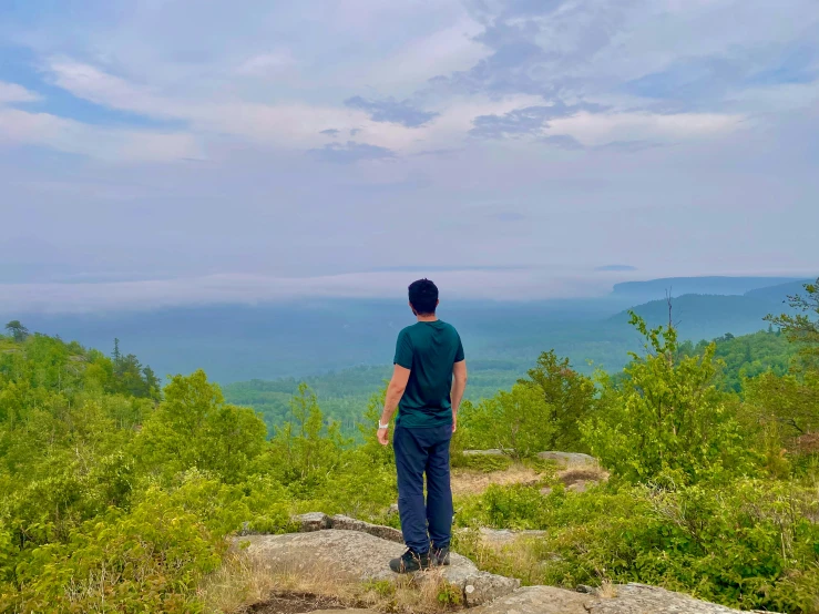 a man standing on top of a stone hillside