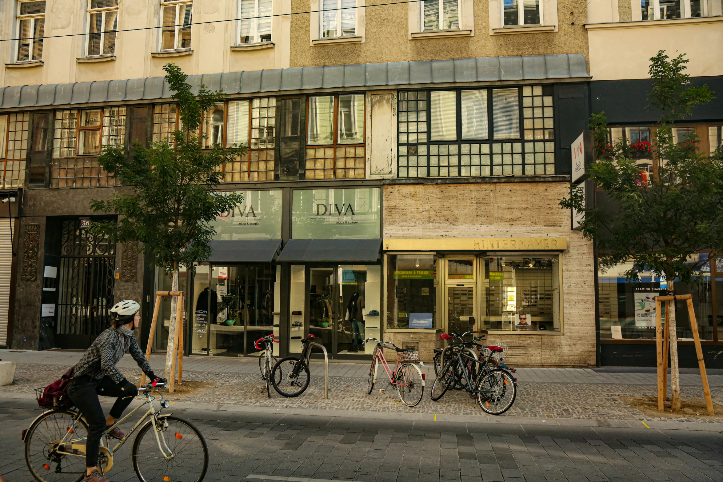 an older building with bicycles parked on the street