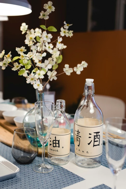 a vase with flowers sits on the dining table