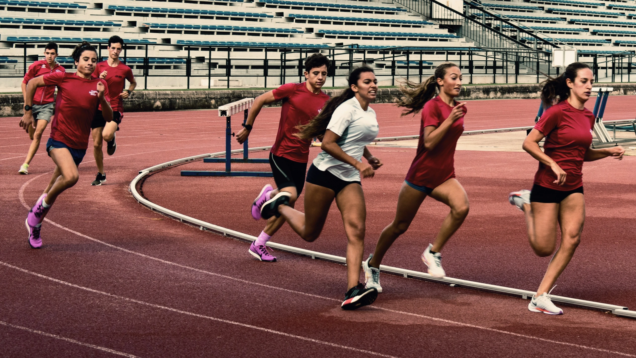 a group of women run along a track