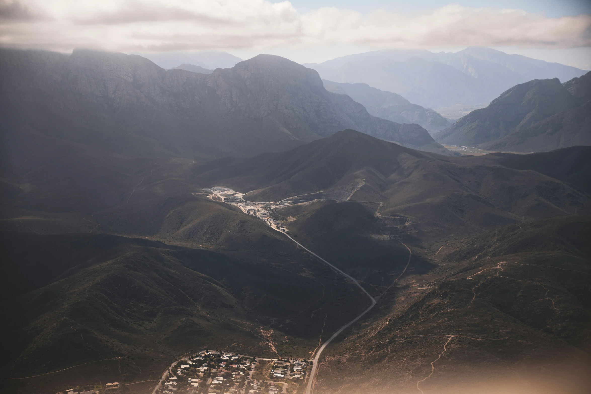 a scenic landscape of mountains and a road