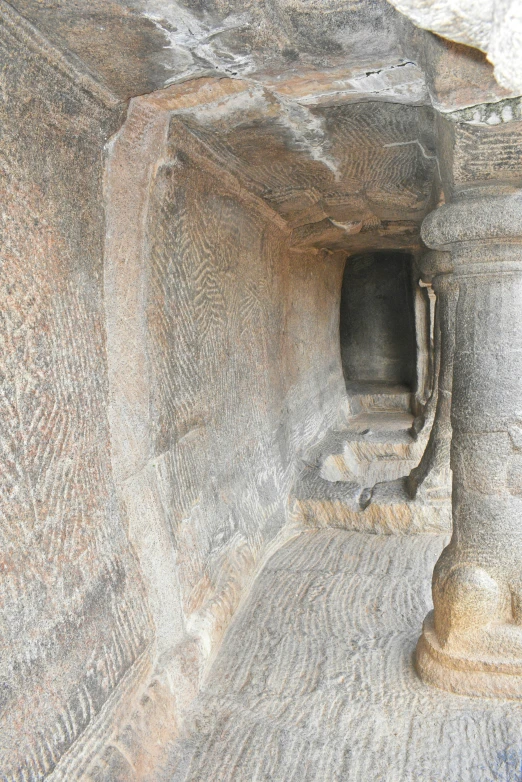 a very small cave sitting inside of a big stone