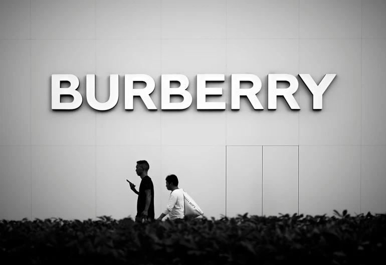 two people walking near the name of a business establishment