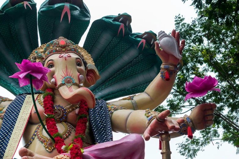 a statue with many leaves and petals on it