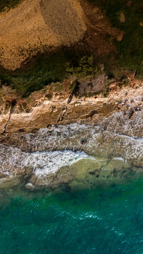 an ocean beach with waves hitting the rocks