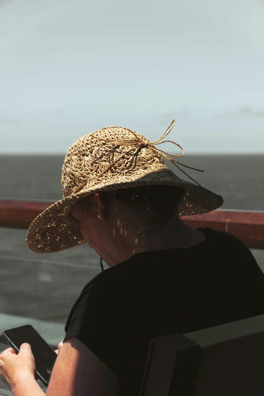 a person on a ship uses their cell phone