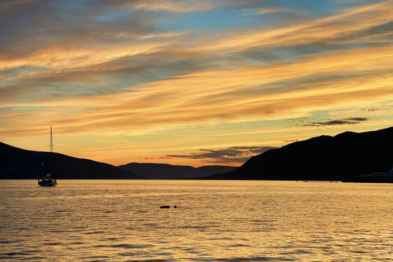 boats in the water at sunset on a bright day