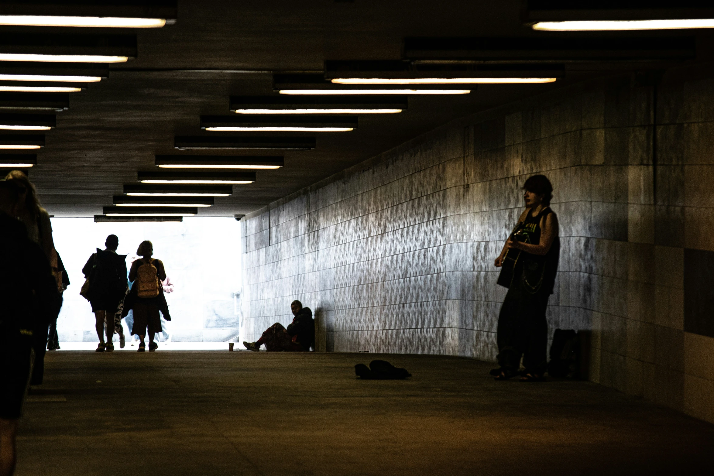 a group of people in an area with concrete walls