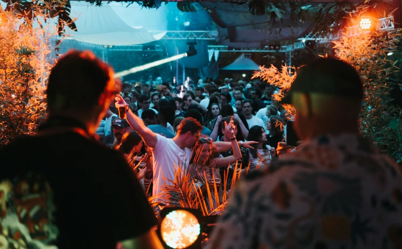 a group of people standing in front of a party tent