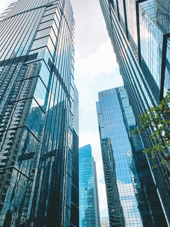 a row of very tall skyscrs that are all along a street