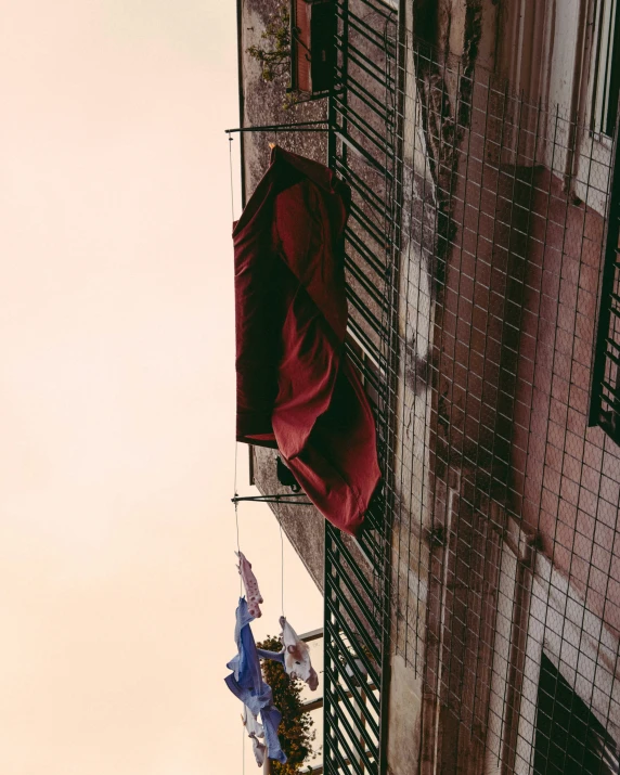 there are some flags on the balcony of the building