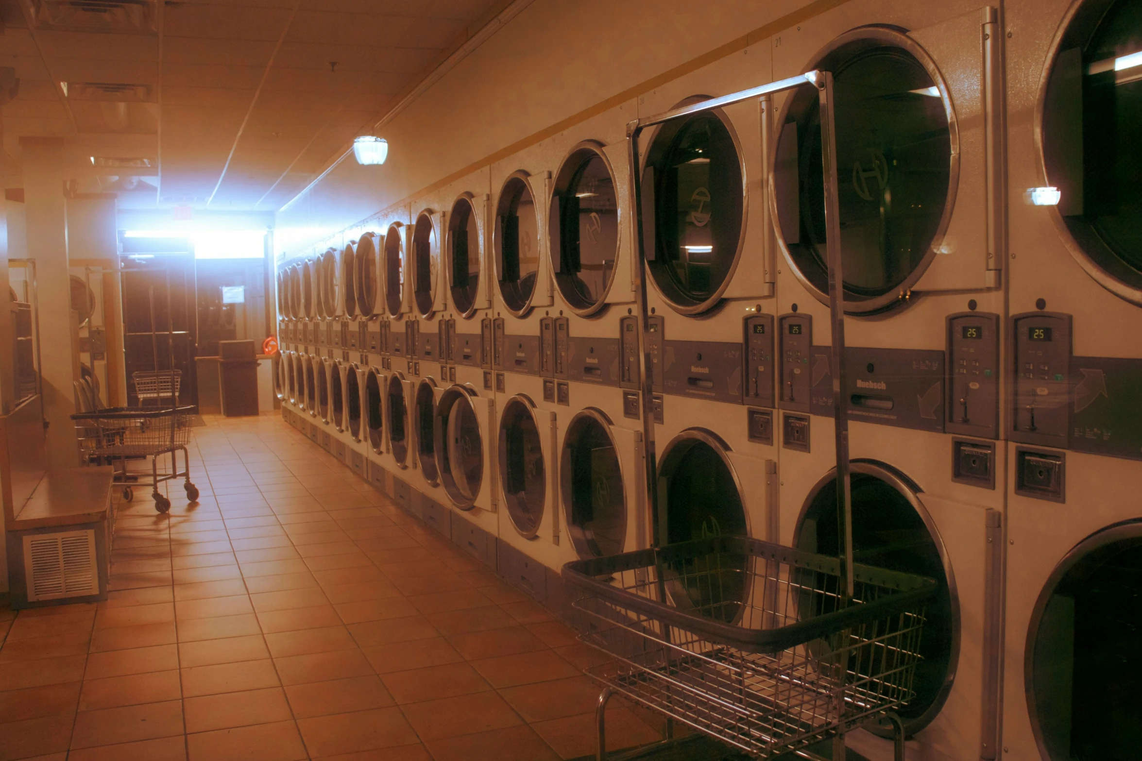 row of industrial washers in large industrial room