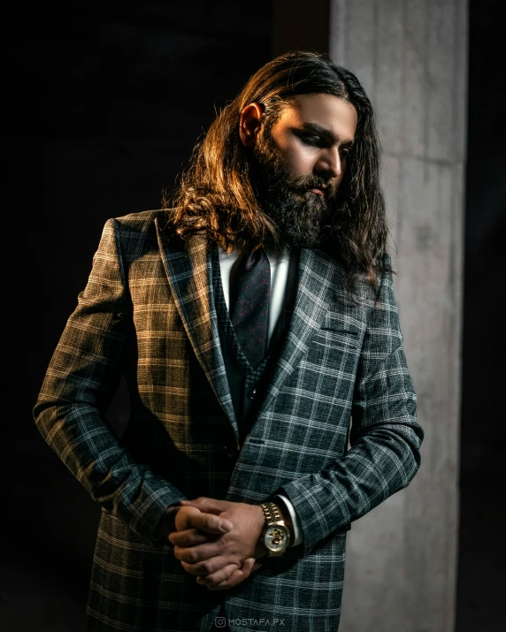 a bearded man with long hair and a suit