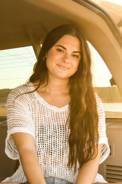 a woman sitting in the passenger seat of a vehicle