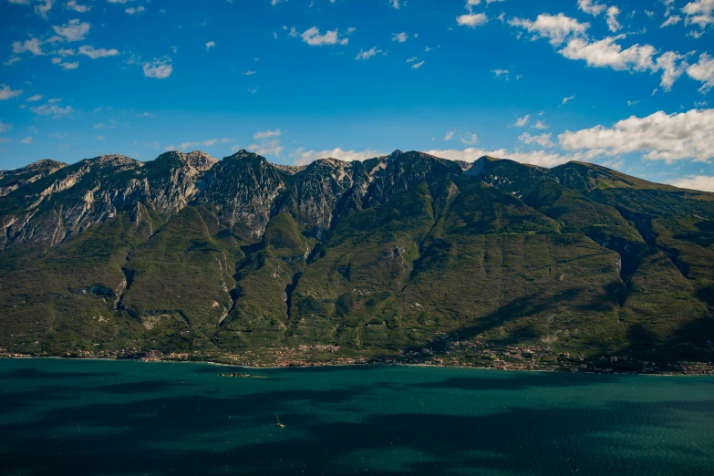 a small body of water with mountains in the background