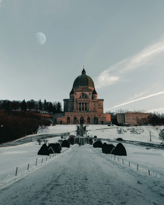 a building with a roof is surrounded by snow