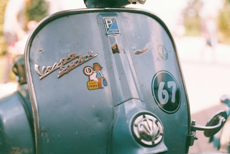 the back end of a moped with stickers